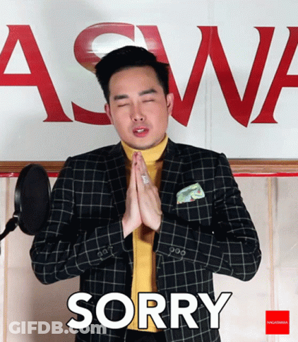 Man In Suit Saying Sorry In Front Of Aswa Sign GIF
