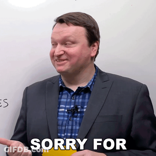 Man In Suit Saying Sorry In Front Of Whiteboard GIF