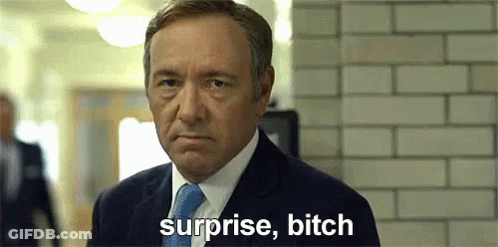 Man In Suit Saying Surprise Bitch In Front Of Brick Wall GIF
