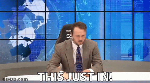 Man In Suit Saying This Just In In Front Of World Map GIF