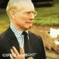 Man In Suit Saying Tight Hand To Chest GIF