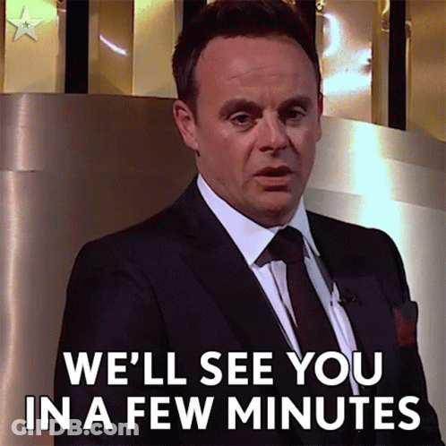 Man In Suit Saying We'll See You In A Few Minutes GIF