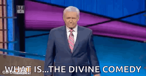 Man In Suit Saying What Is The Divine Comedy In Front Of Purple Wall GIF