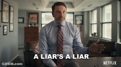 Man In Suit Says A Liar's A Liar Sitting At Table GIF