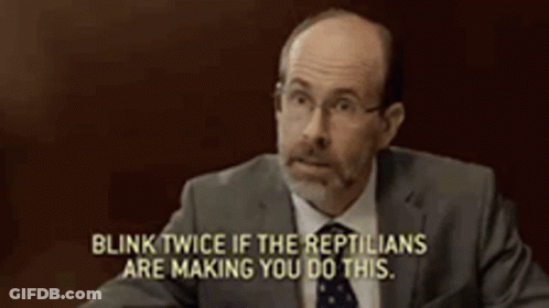 Man In Suit Says Blink Twice If The Reptiles Are Making You Do This GIF