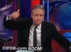 Man In Suit Says Boom Into Microphone GIF