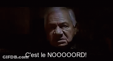 Man In Suit Says C Est Le Noooord In Dark Room GIF