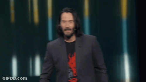 Man In Suit Says Check This Out In Yellow Letters GIF