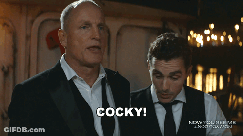 Man In Suit Says Cocky In Front Of Another Man GIF