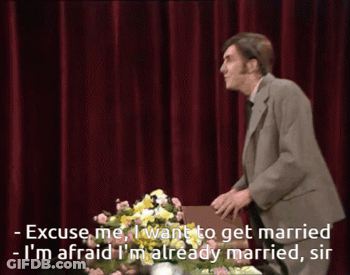 Man In Suit Says Excuse Me With Flowers GIF