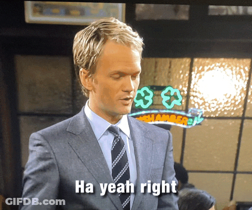 Man In Suit Says Ha Yeah Right At Shamrock Sign GIF
