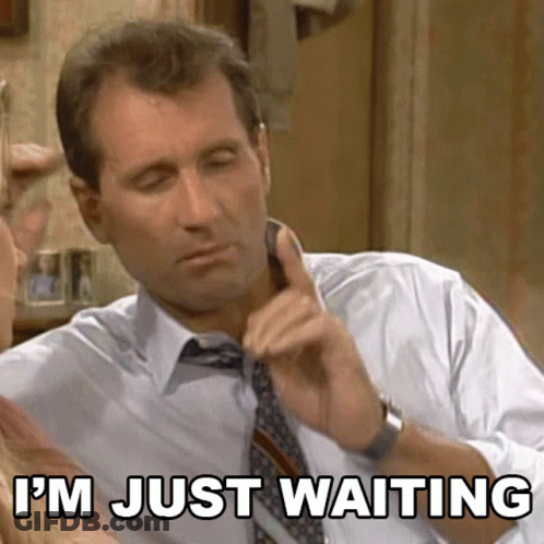 Man In Suit Says I'm Just Waiting On Phone GIF