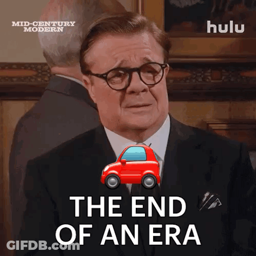 Man In Suit Says The End Of An Era Next To Red Car GIF