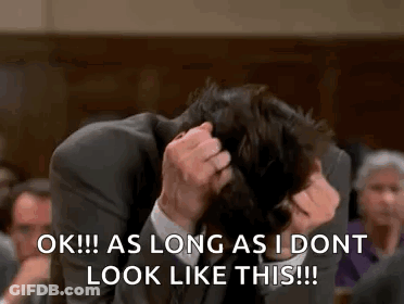 Man In Suit Scratching Head In Courtroom GIF