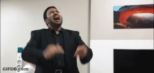 Man In Suit Screaming In Living Room With Volcano GIF