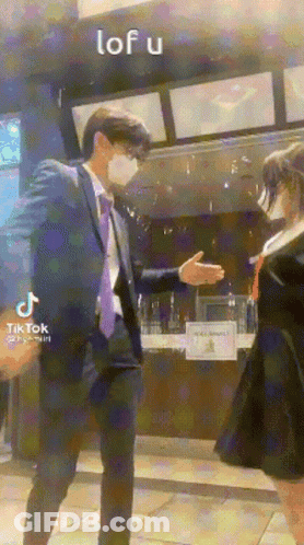 Man In Suit Shaking Hands With Girl In School Uniform GIF