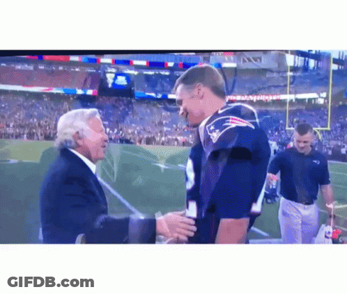 Man In Suit Shaking Hands With Man In Patriots Jersey GIF