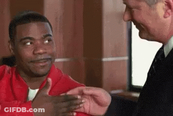 Man In Suit Shaking Hands With Man In Red Jacket GIF