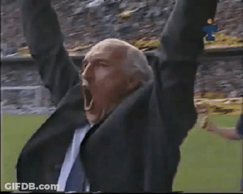 Man In Suit Shouting In Stadium GIF