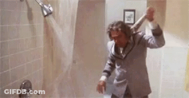Man In Suit Showering Holding Bat GIF