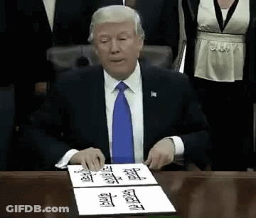 Man In Suit Signing Document At Desk GIF