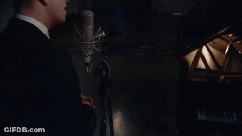 Man In Suit Singing Into Microphone GIF