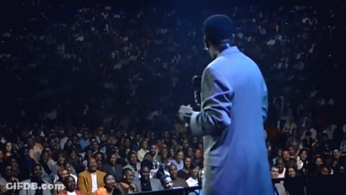Man In Suit Singing Into Microphone In Front Of Crown GIF