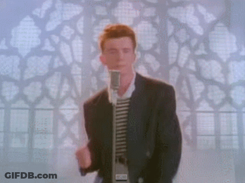 Man In Suit Singing Into Microphone In Front Of Stained Glass Window GIF