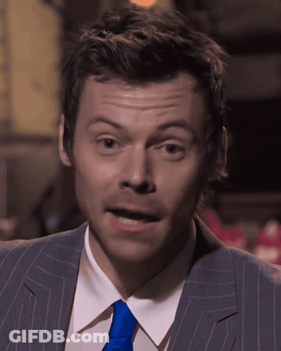 Man In Suit Singing Into Microphone On Stage GIF