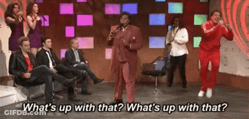 Man In Suit Singing Into Microphone With Audience GIF