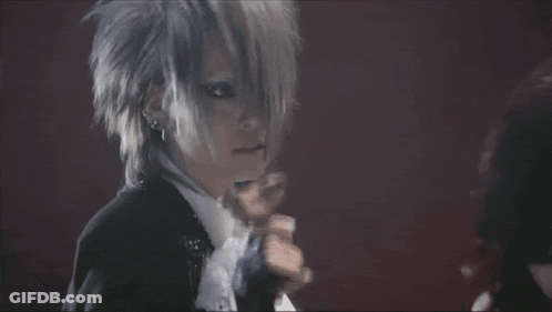 Man In Suit Singing Into Microphone With Gloves GIF