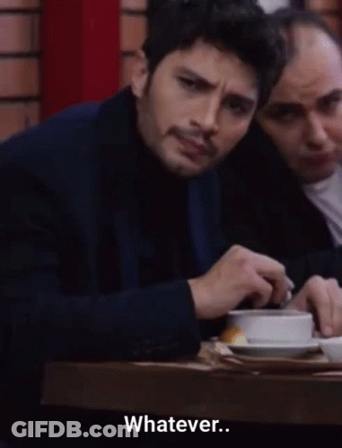 Man In Suit Sits At Table Says Whatever GIF