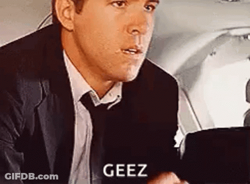 Man In Suit Sitting And Talking In Airplane Back Seat GIF