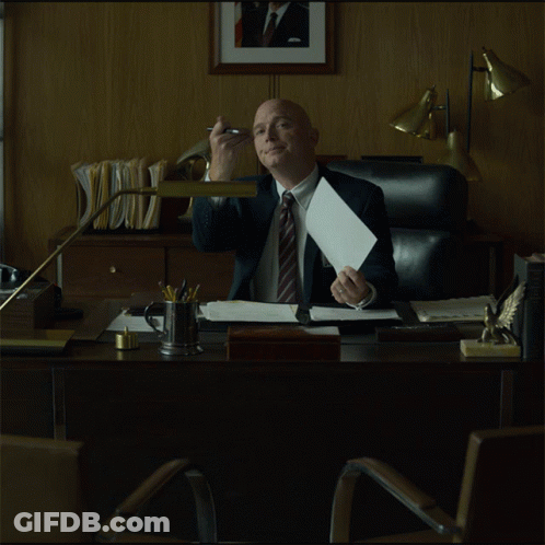 Man In Suit Sitting At Desk GIF