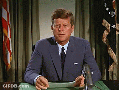 Man In Suit Sitting At Desk GIF