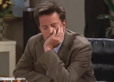 Man In Suit Sitting At Desk GIF