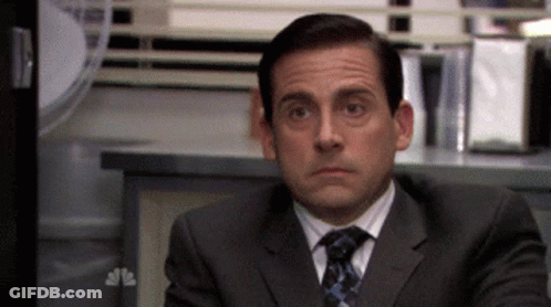 Man In Suit Sitting At Desk GIF