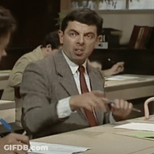 Man In Suit Sitting At Desk In Classroom GIF
