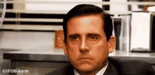 Man In Suit Sitting At Desk GIF