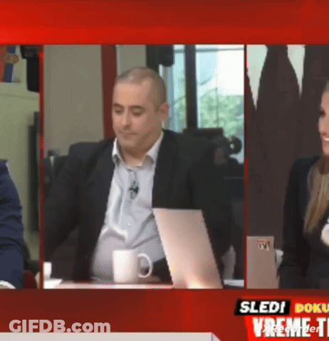 Man In Suit Sitting At Desk GIF