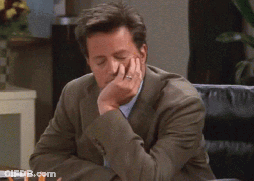 Man In Suit Sitting At Desk GIF