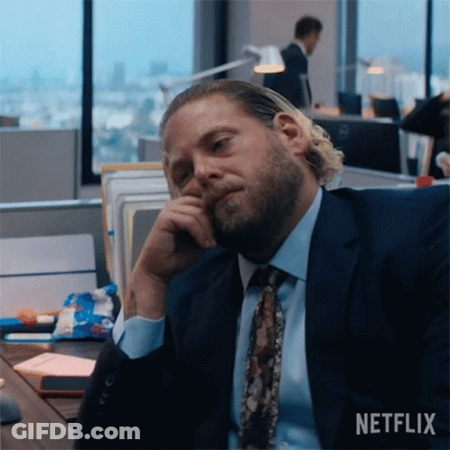 Man In Suit Sitting At Desk GIF