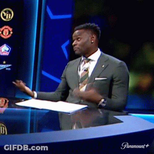 Man In Suit Sitting At Desk GIF