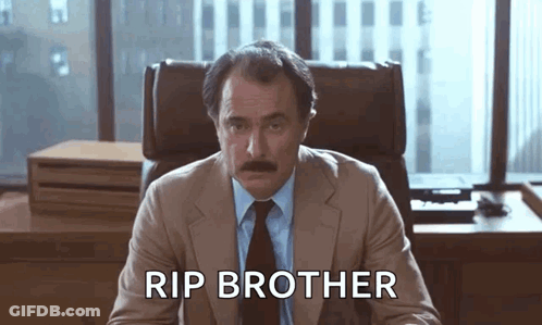 Man In Suit Sitting At Desk Rip Brother GIF