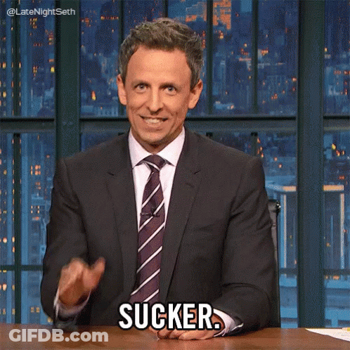 Man In Suit Sitting At Desk Saying Sucker GIF
