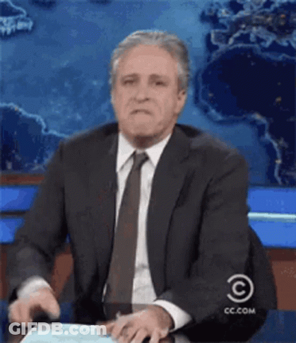 Man In Suit Sitting At Desk With CC.com Logo GIF