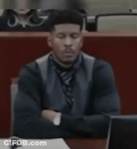 Man In Suit Sitting At Desk With Eyes Closed GIF