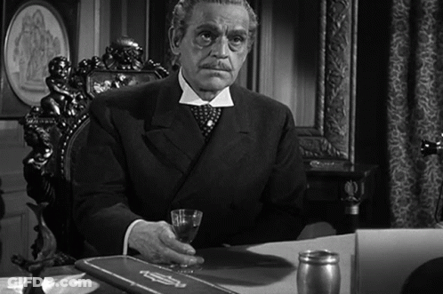 Man In Suit Sitting At Desk With Glass GIF