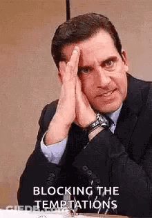Man In Suit Sitting At Desk With Hands On Face GIF