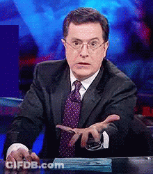Man In Suit Sitting At Desk With Hands Outstretched GIF